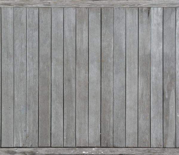 New grey wooden planks installed in vertical fashion.